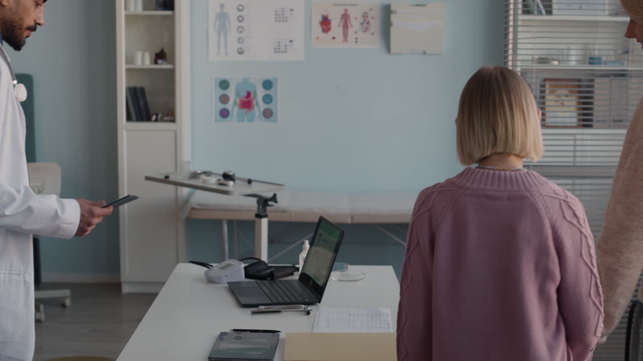 Doctor with patient in examination room