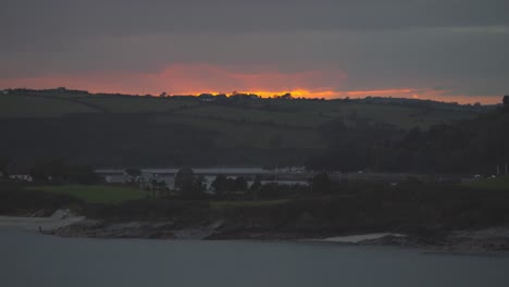 beautiful sunrise over the hills and the water