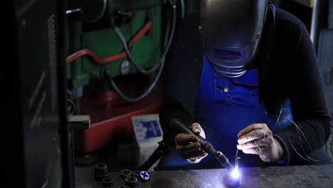 welder engineering technician or repairman steel factory worker wearing industrial uniforms work ironwork welding with sparks flying in a heavy machine with sparks flying, industrial safety first