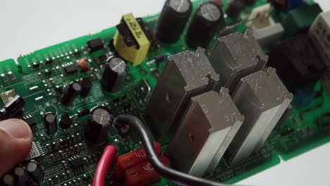 close-up of a circuit board components under a thorough inspection of an expert technician