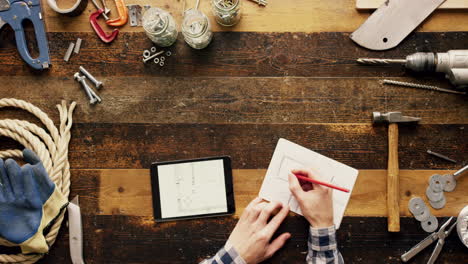 person designing on workbench with tools