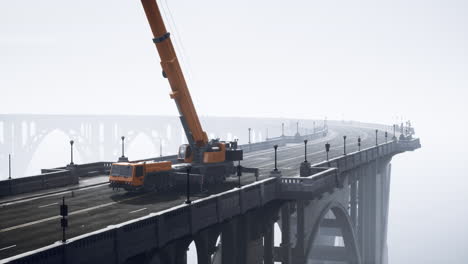 vintage bridge under construction in misty conditions with crane