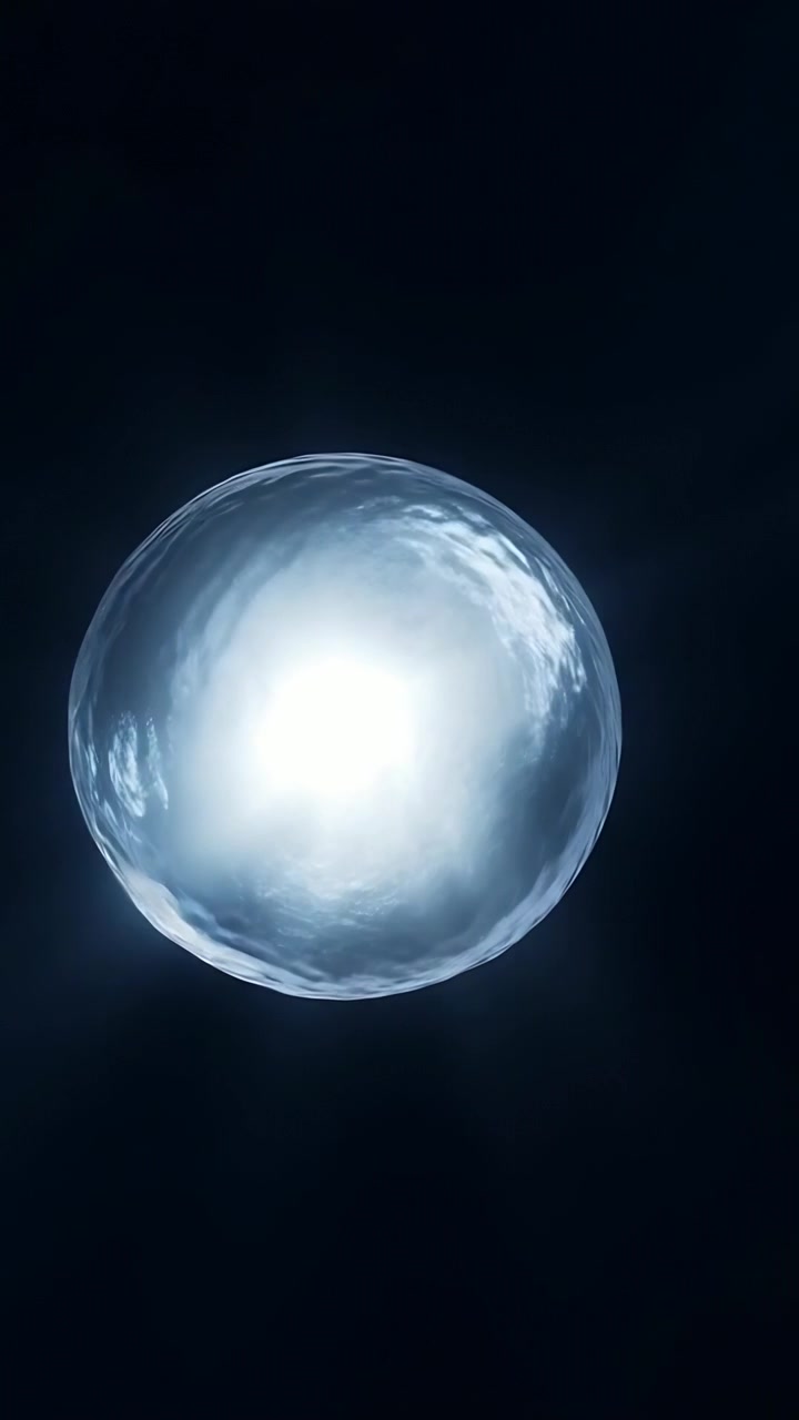 Vertical video: Emerging lower left orb drifting to center in void brightening to show inner clouds