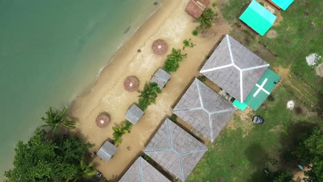 cinematic shot , aerial view of a resort on the coast, white sand beach, bungalows in roxas, palawan