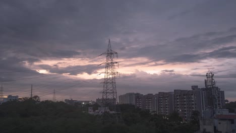 pink sky time lapse dusk hour, vibrant and contrast sky with a tower in frame. clouds passing by. day to night holy grail time lapse. hyderabad, india.