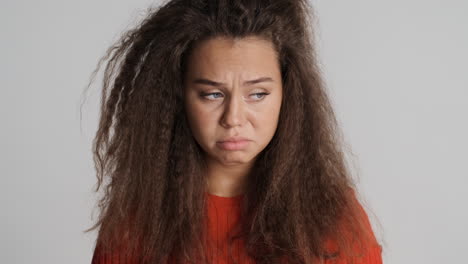 sad caucasian curly haired woman.