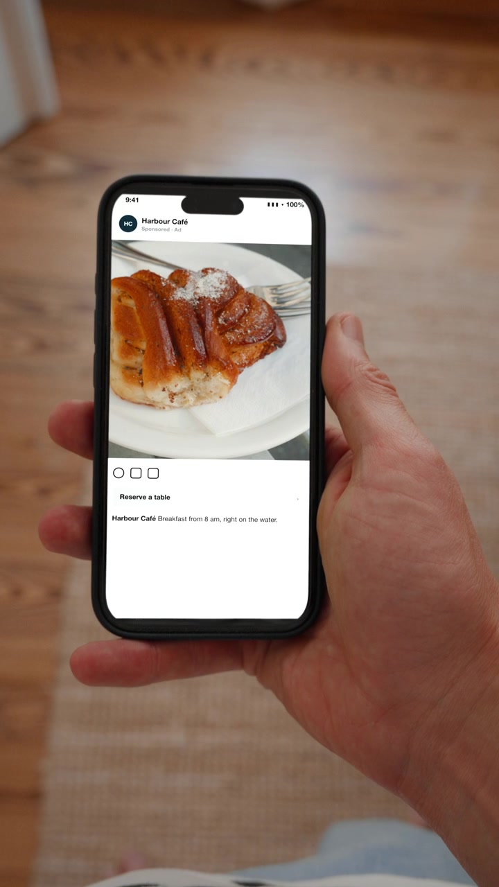 An advertisement carries a visible label stating the content was generated by artificial intelligence. Point of view shot in vertical format with the phone held in the hand.