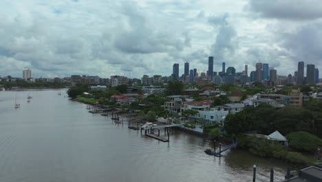 brisbane city river quay docks sailboats australia aerial drone brissysouth bank park skyline skyscraper cranes morning sun rainy clouds aussie summer autumn winter upward motion