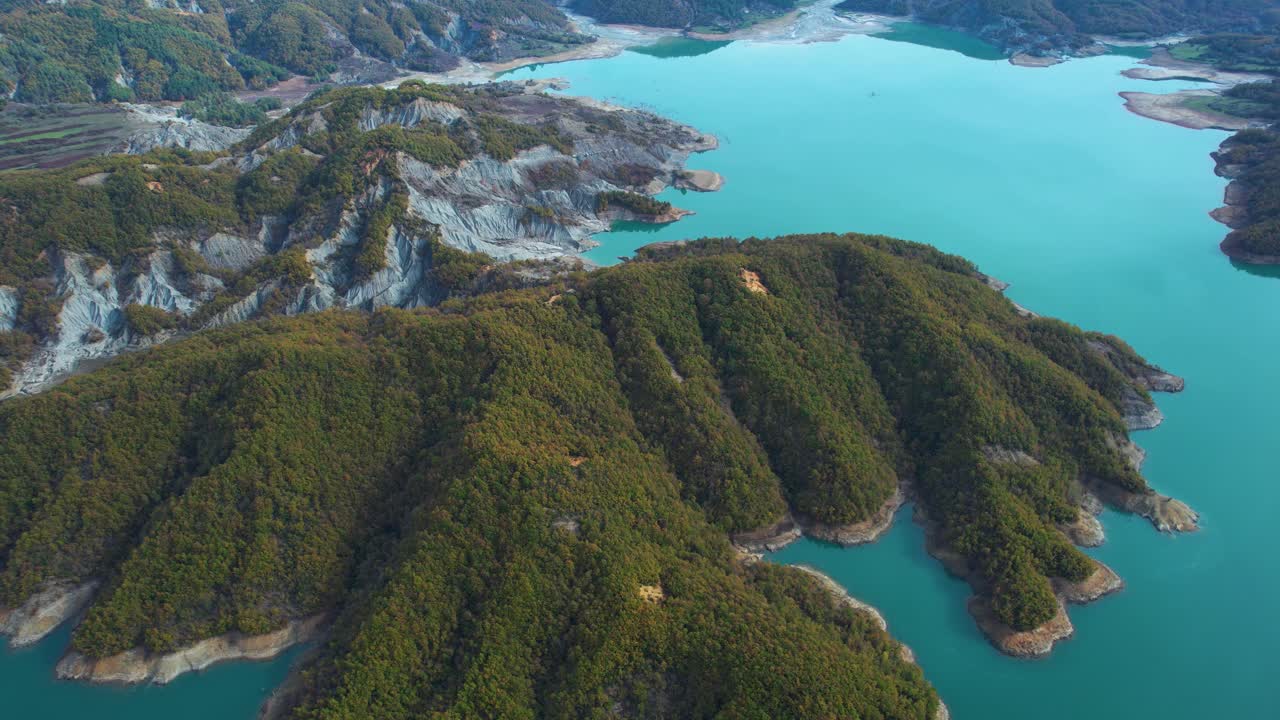 Aerial View of a Mountainous Island in a Turquoise Lake