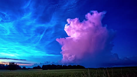 low angle shot of blue noctilucent clouds above rural agricultural farmland in summer during evening in timelapse