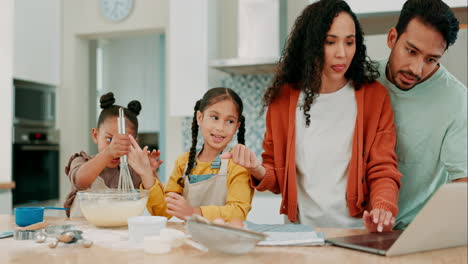 laptop, recipe and a family baking in the kitchen
