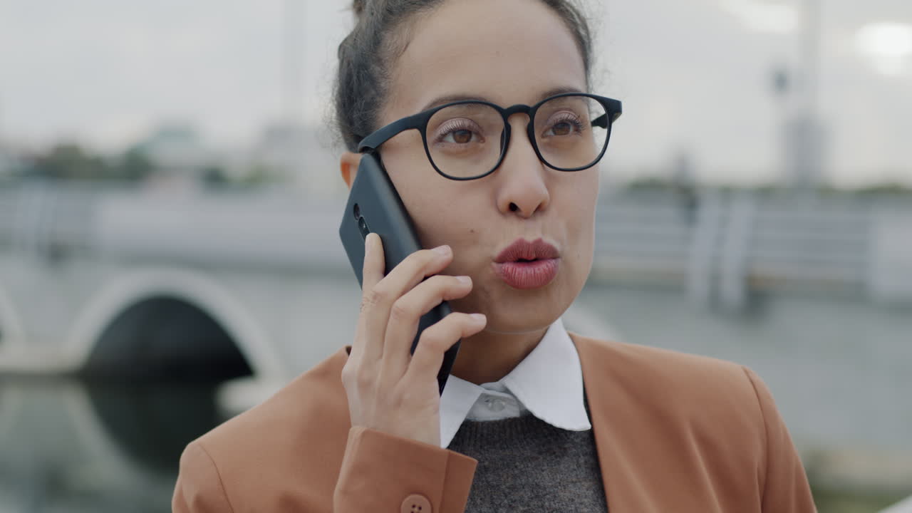 사업가 여성이 야외에서 전화로 이야기하고 있습니다.