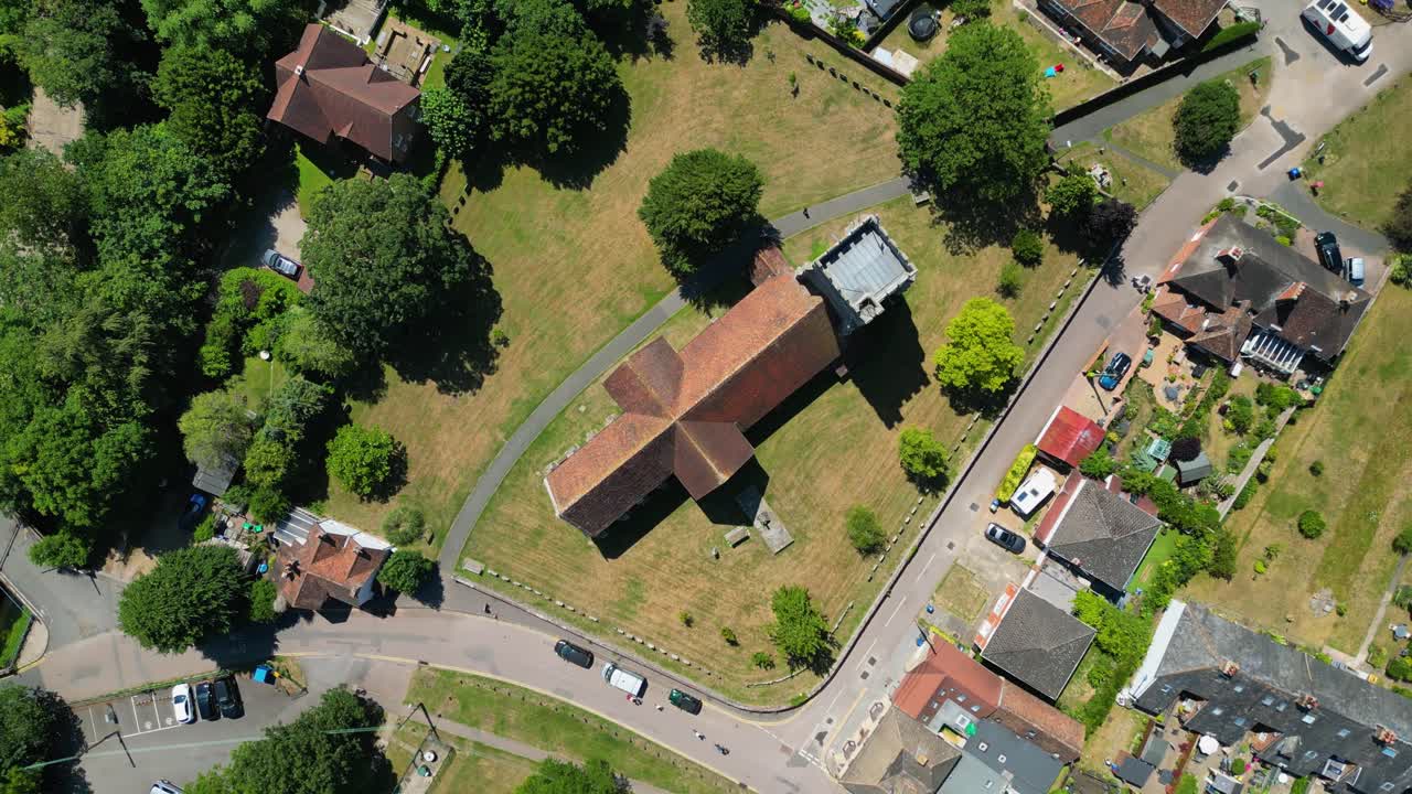 A top-down roll-shot of St Mary's church in Chartham, with parts of the village in view