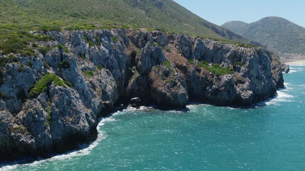 Spiaggia di Cala Domestica Secluded Cove On The Southwestern Coast Of Sardinia Near Buggerru In Italy. Aerial Pullback Shot