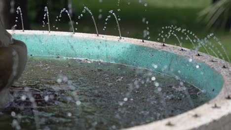 close-up of water jets in a turquoise fountain basin