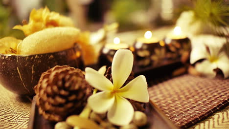 Spa-and-Wellness-Treatment-Decorations-accessories-Inspirations-with-herbal,-sponge-scrub,-aroma-candles,-plumeria-frangipani-flowers,-and-towels,-for-body-and-skin-care-therapy-and-relaxation