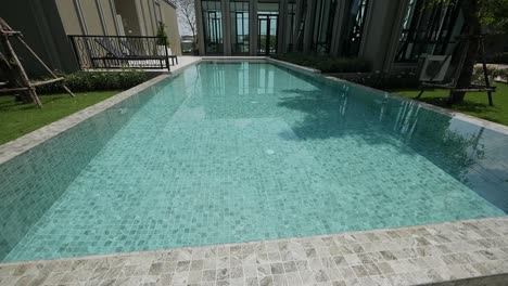 modern contemporary pool house exterior design with green garden
