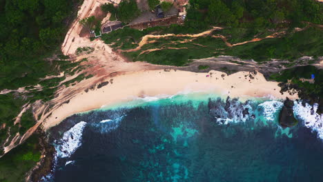 diamond beach below steep cliff washed by foamy sea waves, nusa penida