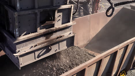 a rapid loading system loads manganese ore into a rail wagon on a mine