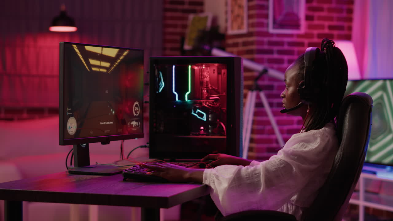 African american woman streaming first person shooter while talking in headset