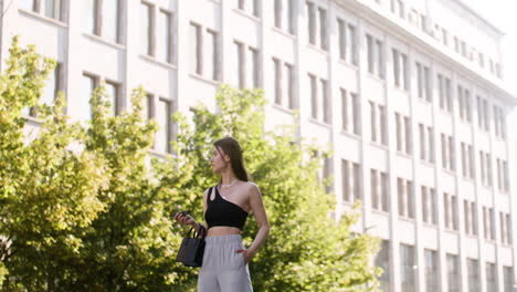 young fashionable woman walking down the street