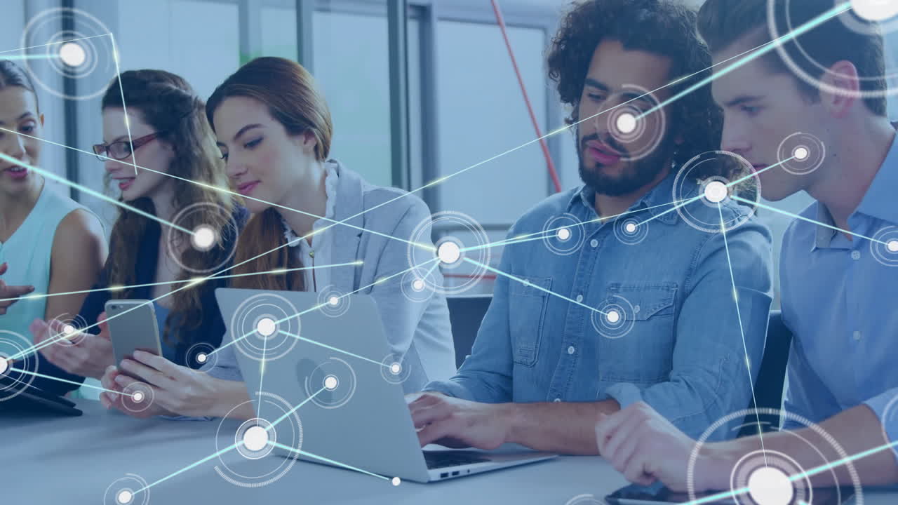 Working on laptops, diverse group with network connections overlay in office