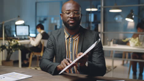 african american businessman giving presentation on camera in office