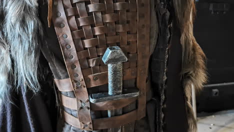 close up on a authentic viking outfit with leather jacket and sword