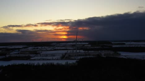 aerial view of windmills during cold winter evening sunset.camera movement: truck left