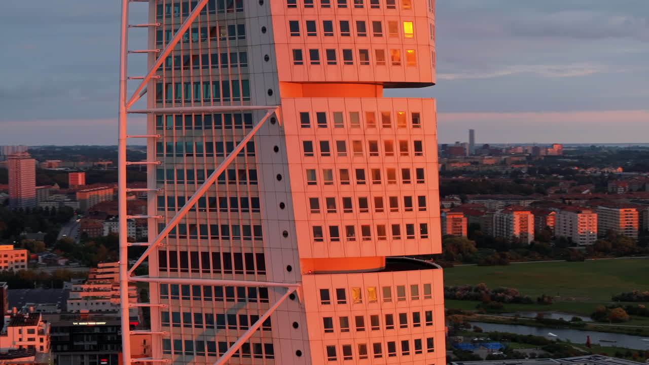 Aerial drone view of Turning Torso residential skyscraper in Malmo, Sweden at sunset