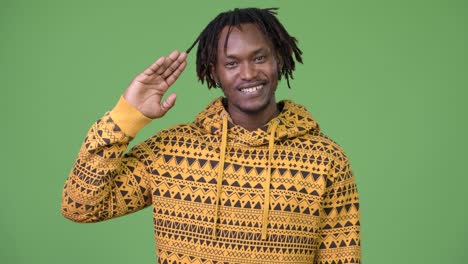 young happy african man smiling while saluting