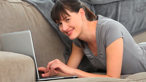 brunette enjoying a chat on a laptop