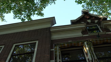 a view of traditional dutch culture architecture houses along lage gouwe street in gouda, netherlands