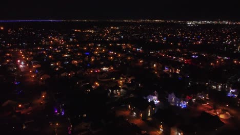 a view of a residential area in the city of saint constant at night covered in snow illuminated with street lights, quebec , canada
