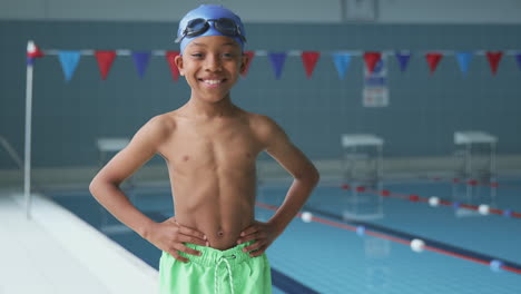 Portrait-Of-Boy-Standing-By-Edge-Of-Swimming-Pool-Ready-For-Lesson