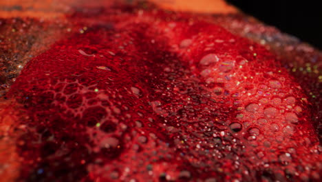 red liquid with bubbles and glitter