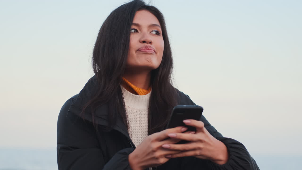 Asian girl using mobile phone.