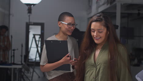 Film-Director-Talking-With-Male-And-Female-Actors-Holding-Scripts-Rehearsing-For-Shooting-Movie-Or-Video-In-Studio-5