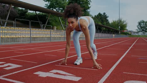 woman preparing to run on a track