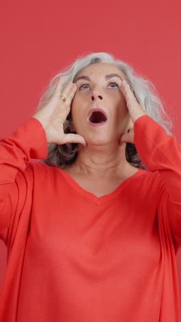 Senior woman showing expressions of shock and surprise