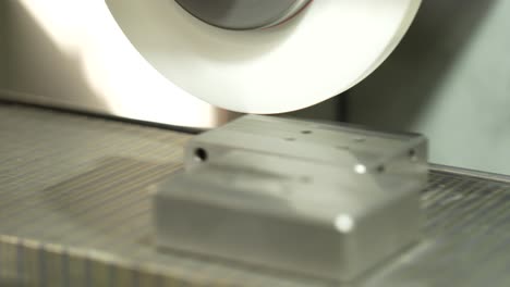 macro close up shot of metal grinding machine trimming metal part