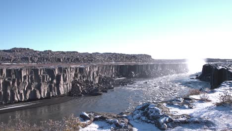 rocky canyon below the dettifoss river waterfall in winter, iceland