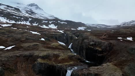 scenic klifbrekkufossar waterfall in east iceland - aerial pullback