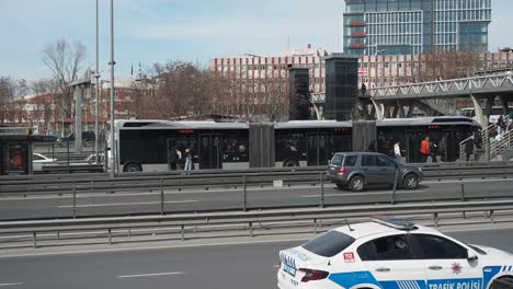 city street scene with bus station and highway traffic