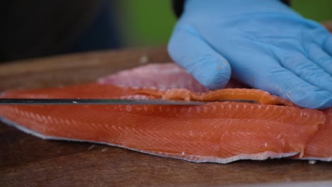 slow motion close-up of cutting a salmon