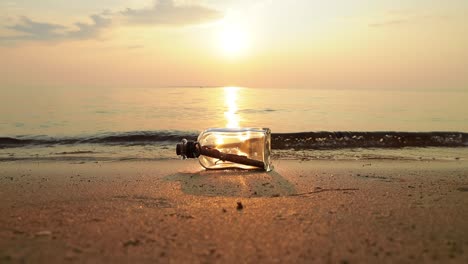 message in the bottle against the sun setting down