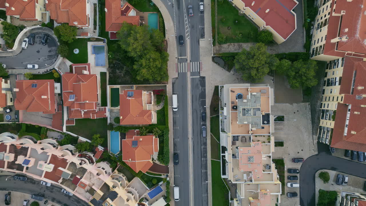 Top view mediterranean town with beautiful red rooftop buildings. Cars driving