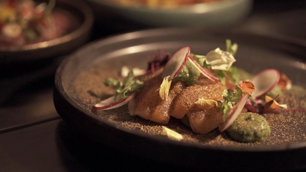 Slow Pan Showing Delicious Sea Urchin Dish in Atmospheric Bar and Restaurant