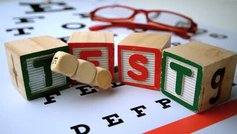 message for eye test spelled out in dice and blocks on an eye test