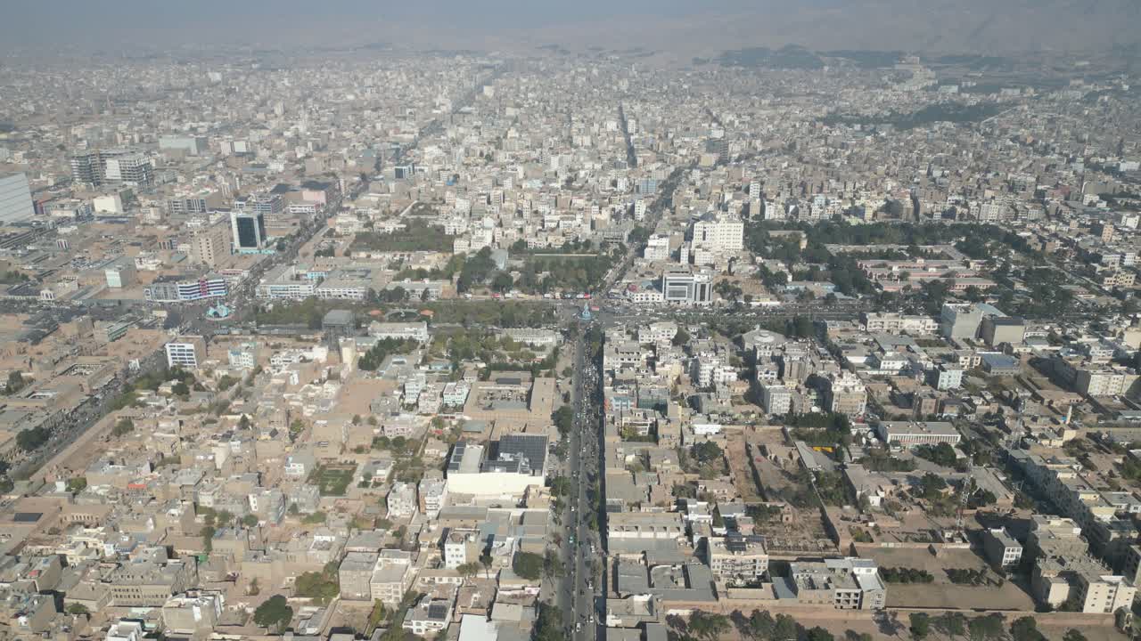 Cars Driving Through Martyr Mirvais Sadeq Boulevard Towards The Farhang Park In Herat, Afghanistan. - aerial shot